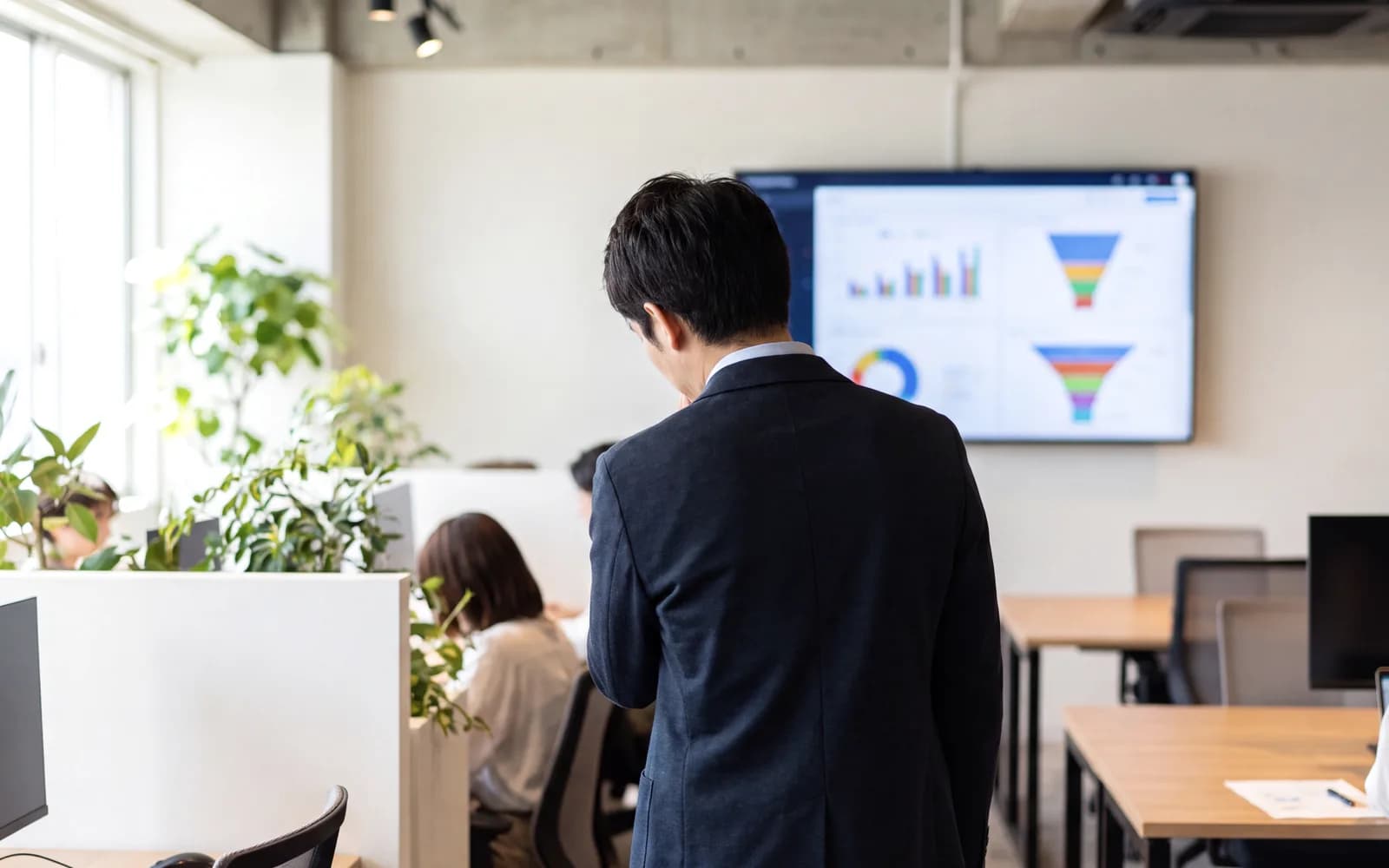 Person at a large monitor covered in hiring charts