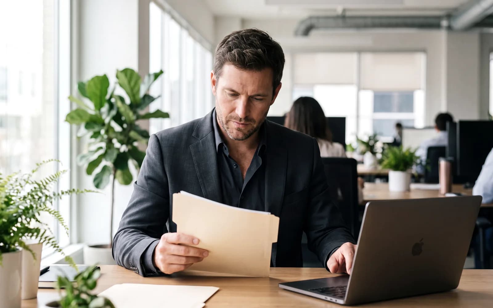 Security reviewer checking compliance documents at a desk