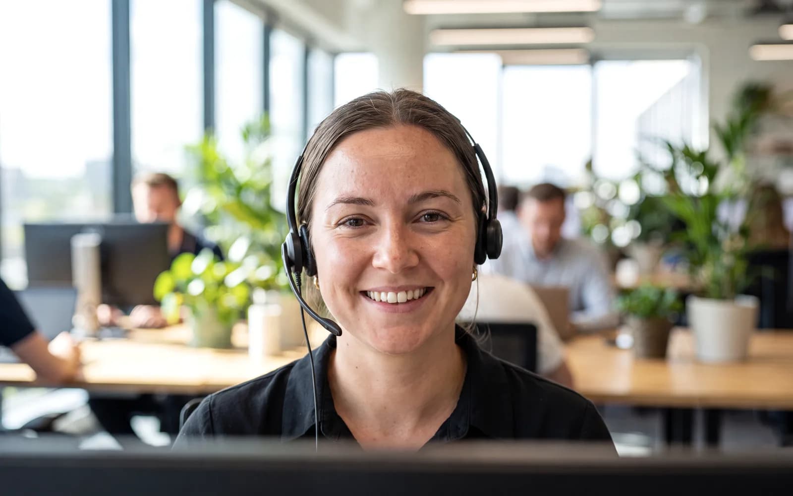 Support specialist wearing a headset, ready to help