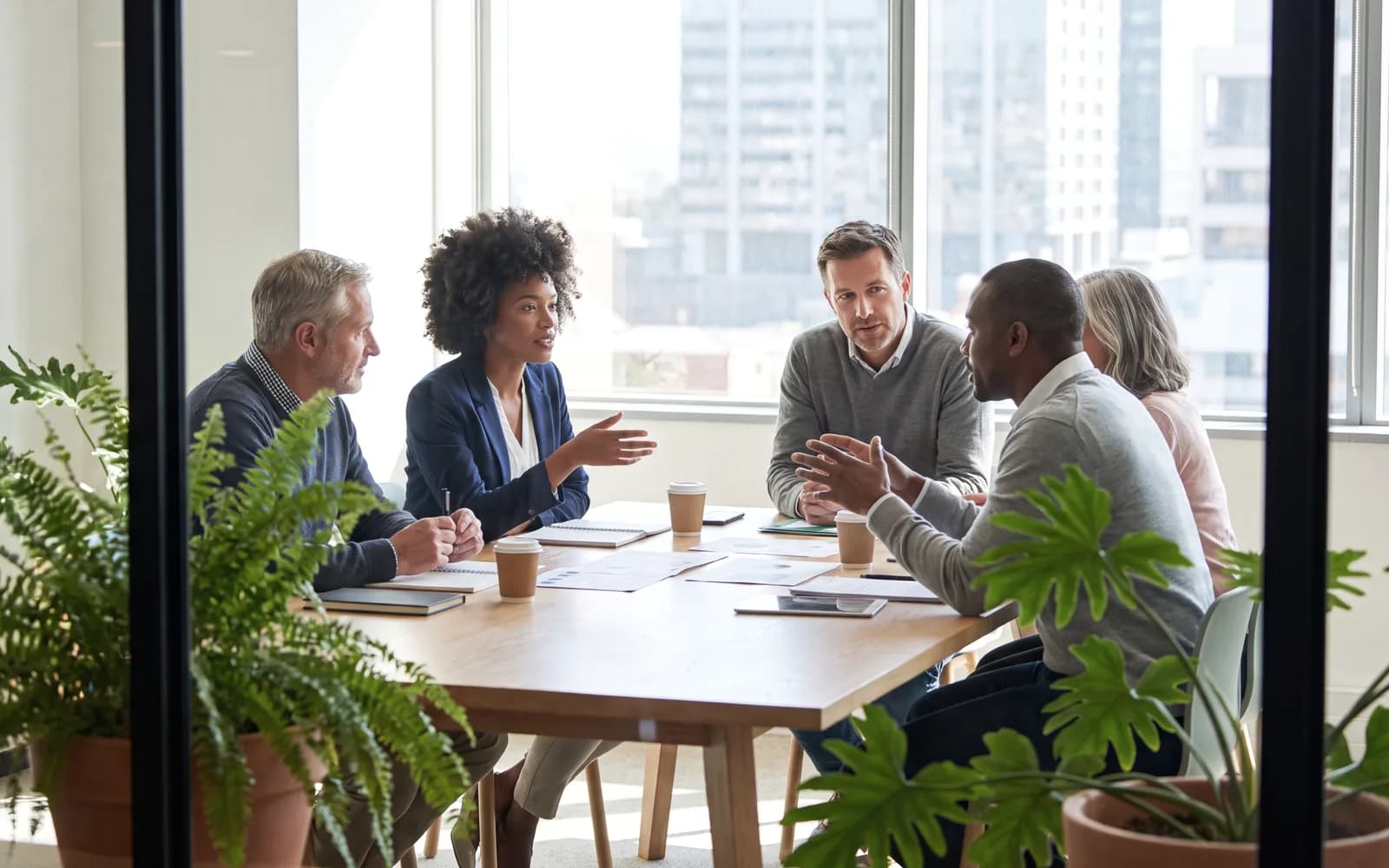 Executive team in a glass boardroom